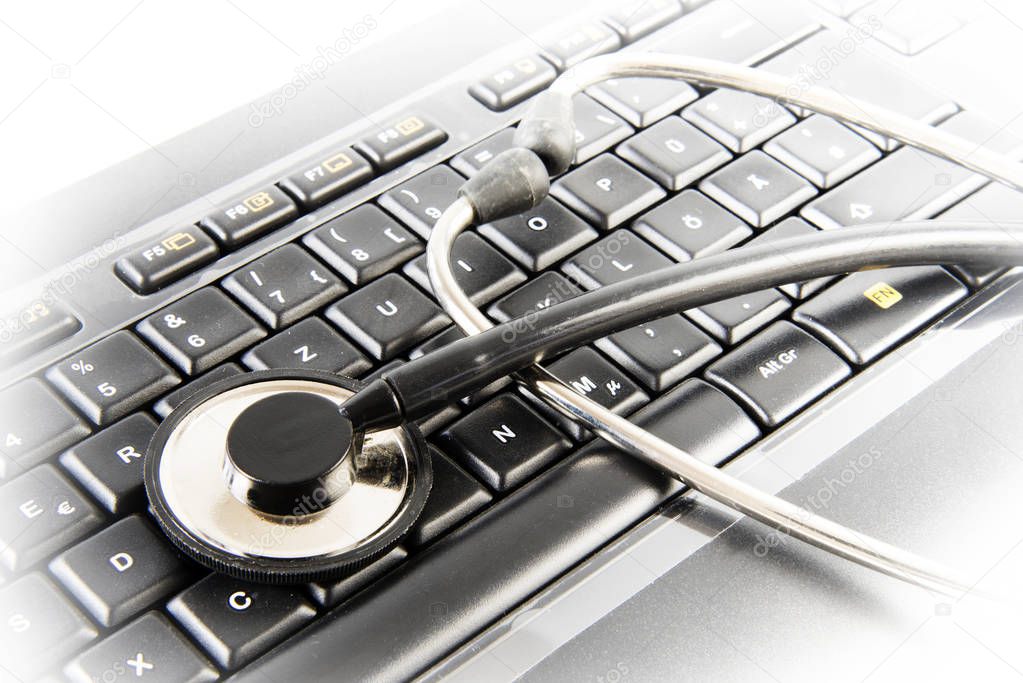 Data protection, stethoscope on a business computer keyboard, concept of antivirus repair service or password theft