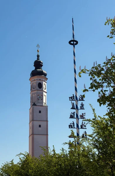 Tour typique de l'église bavaroise et un maibaum traditionnel, mât de mai contre le ciel bleu — Photo