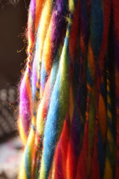 Colorful wool strings for hand spinning on an outdoor craft market, vertical — Stock Photo, Image