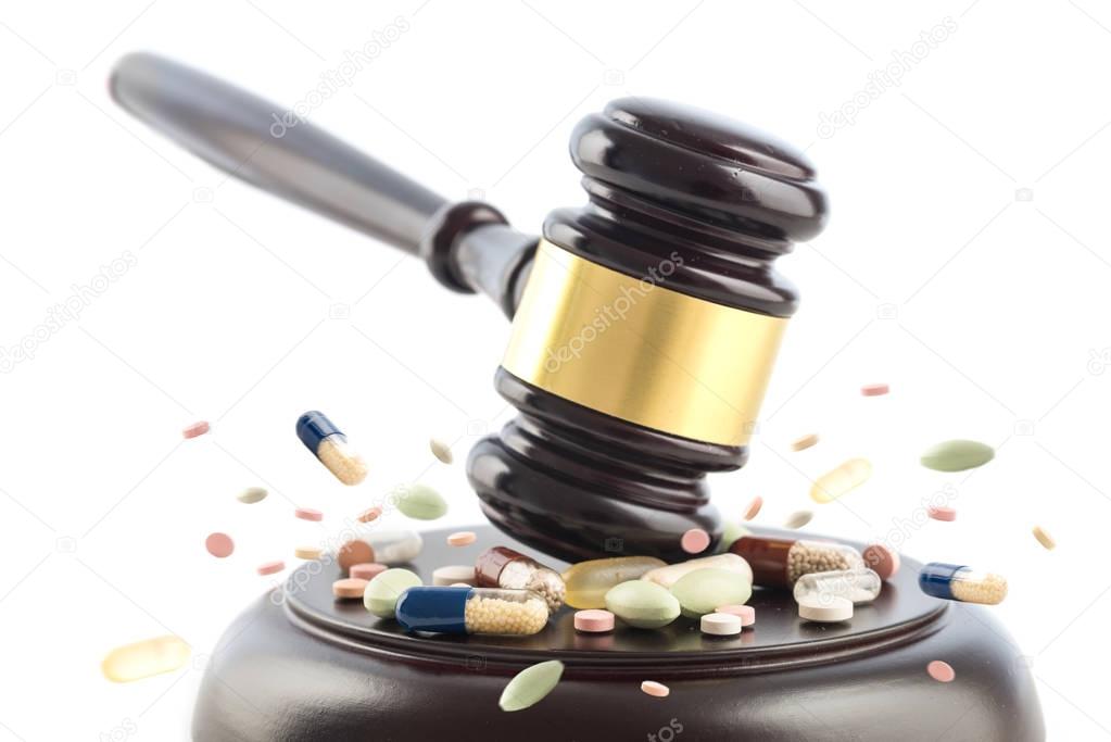 Law gavel beats on tablets and pills,  judge cocept, crime with drugs, medicine or doping, isolated on a white background