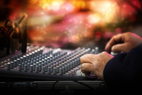 Working sound control panel or mixing console in front of the stage at a music festival concert