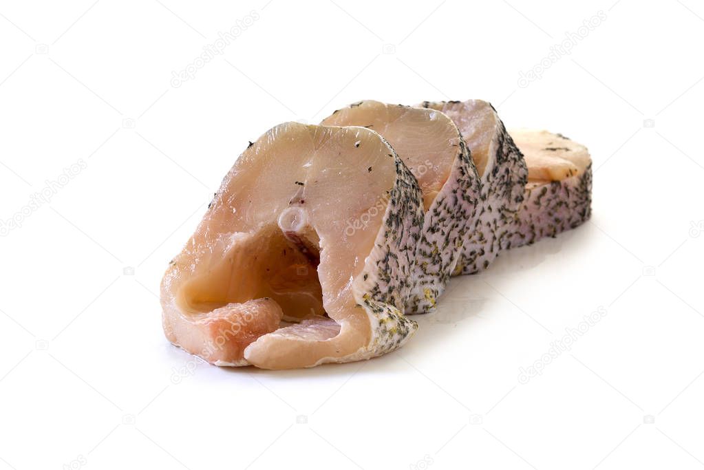 raw northern pike sliced in steaks, fresh fish prepared for grilling or frying isolated on a white background