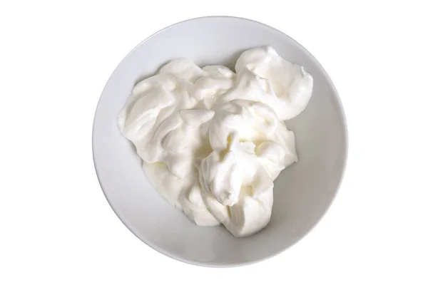 Whipped cream in a bowl isolated on a white background, overhead view from above — Stock Photo, Image