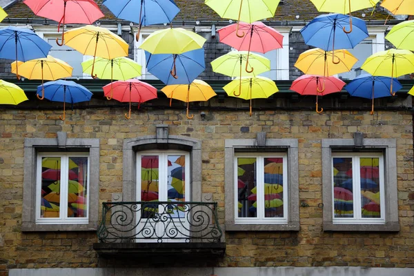 Colorful hanging umbrellas, decoration in the shopping street in he old town of Bastogne, Belgium — Stock Photo, Image