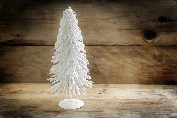 Kleiner Weihnachtsbaum aus weißem Flockendraht vor rustikalem Holzhintergrund mit großem Kopierraum — Stockfoto