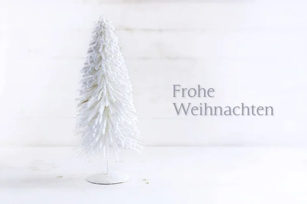 White christmas tree made of flocked wire on  rustic white painted wood with german text Frohe Weihnachten, meaning Merry Cristmas, greeting card — Stock Photo, Image