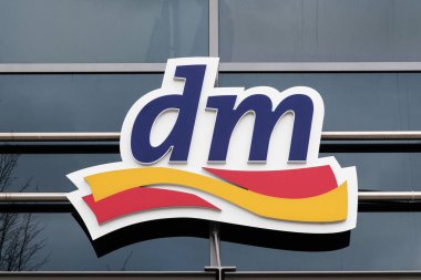 Luebeck, Germany - February 1, 2018: logo of the DM drogeriemarkt store, a German chain of retail drugstores for cosmetics, healthcare and household products clipart