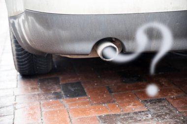 Exhaust from a car with diesel engine emitting gas in the shape of a question mark, concept for the problem of reducing the particulate matter load without driving ban clipart