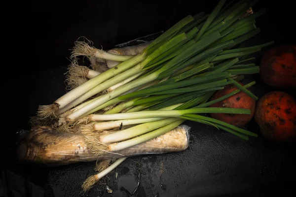 Zöld hagyma és szerves gyökér zöldséget főzni vergetarian étel, rusztikus sötét háttér-val másol hely — Stock Fotó