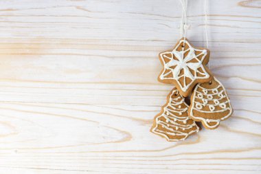 Noel kurabiyeleri beyaz boyalı ahşap bir duvarda asılı, büyük bir kopya alanı