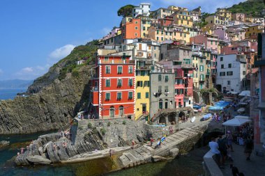 Riomaggiore, İtalya, 5 Temmuz 2019: Riomaggiore, İtalya 'nın Liguria kentinde Akdeniz kıyısındaki Cique Terre kentlerinden biri olan renkli evleri ve küçük bir limanı olan antik bir köydür.