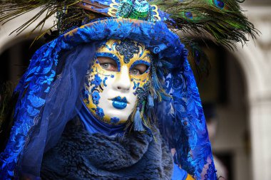 Hamburg, Germany, February 08, 2020: Female mask with blue costume at the carnival celebration Maskenzauber, that means Magic Masks, a street festival in Hamburg on the Alster as a tribute to the original event in Venice