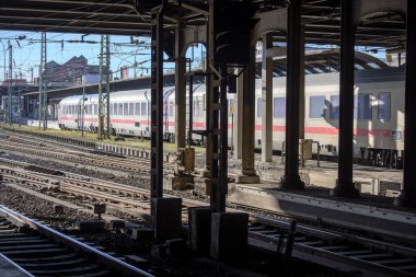 Hamburg, Germany, February 05, 2020: Older passenger train on a roofed track behind steel pillars in the main station of Hamburg
