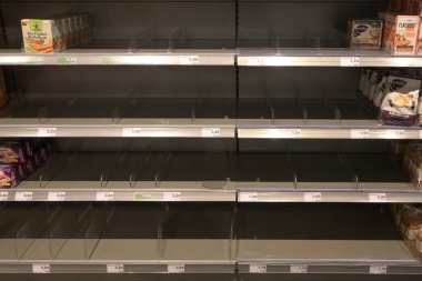 Ratzeburg, Almanya, 18 Mart 2020: Alışverişçiler curonavirüs krizi, covid-19 salgını sırasında panikleyip stok yaptıktan sonra bir süpermarkette boş raflar