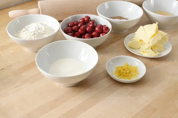 Evde Pişirme Ahşap Mutfak Tezgahında Vişneli Pasta Için Beyaz Kaselerde — Stok fotoğraf