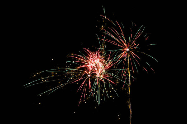 exploding fireworks rocket for the New Year celebration against a black night sky with copy space