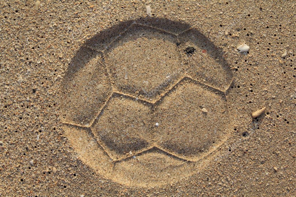Soccer ball footprint on a sand with classical pentagon texture