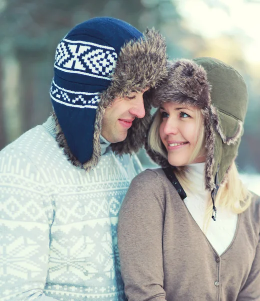 Portrait of happy pretty young smiling couple hugging in warm wi — Stockfoto