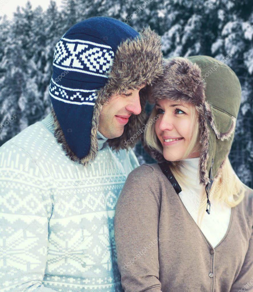Portrait of happy pretty young smiling couple in warm winter day