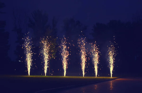 Holidays, celebration concept - many fireworks on ground over ev — Stock Photo, Image