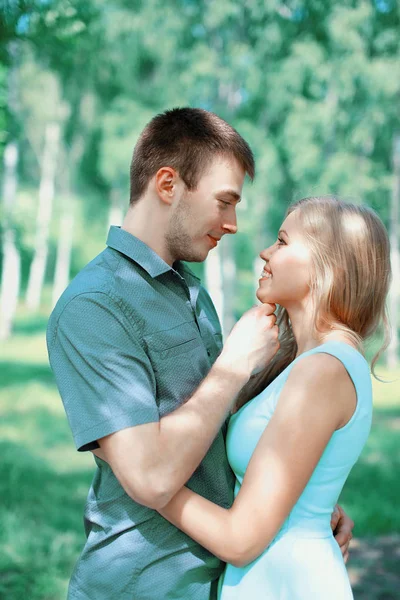 Happy young couple in love, kiss moment, view profile — Stock Photo, Image