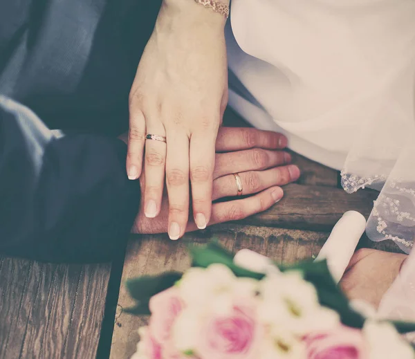 Wedding couple bride and groom holding hands with rings, bouquet — Stock Photo, Image