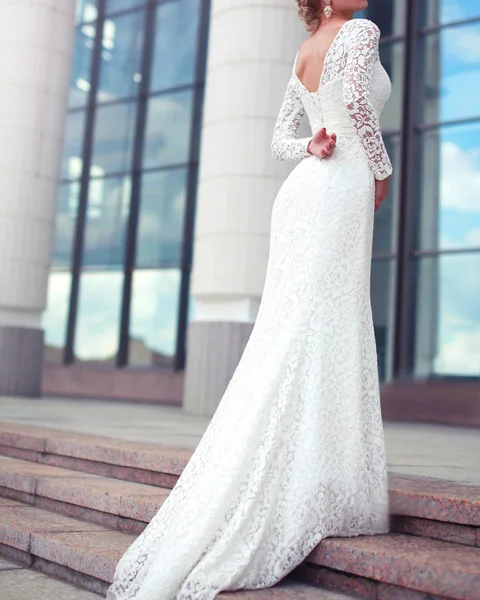 Elegant woman bride in white wedding lace dress posing in the ci — Stock Photo, Image