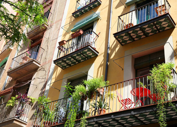 Spanish balconies decorated with pots with green plants