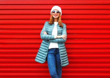 Şehir içinde kırmızı bir arka plan üzerinde oldukça gülümseyen kadın moda