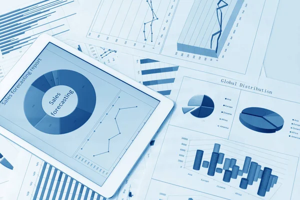 Financial charts on the table with tablet — Stock Photo, Image