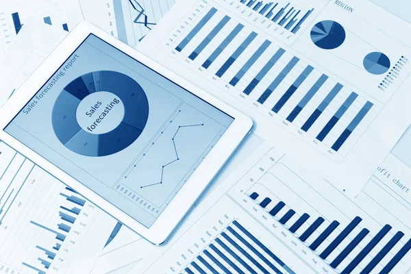 Financial charts on the table with tablet — Stock Photo, Image