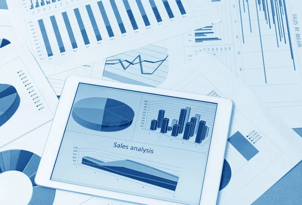 Financial charts on the table with tablet — Stock Photo, Image