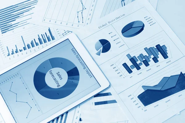 Financial charts on the table with tablet — Stock Photo, Image