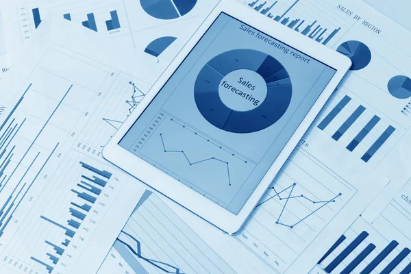 Financial charts on the table with tablet — Stock Photo, Image