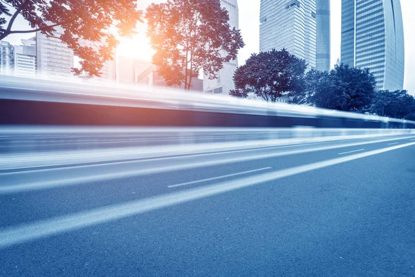 Busy asphalt road in modern city under twilight — Stock Photo, Image