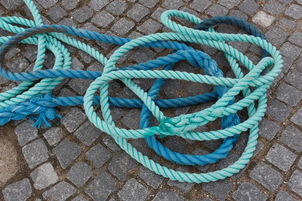 Blue and light blue ropes on stone ground — Stok fotoğraf
