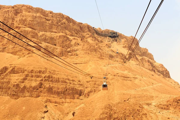 stock image Cable car to ruins of palace and fortress Masada on Judaean Desert rock plateau, Israel