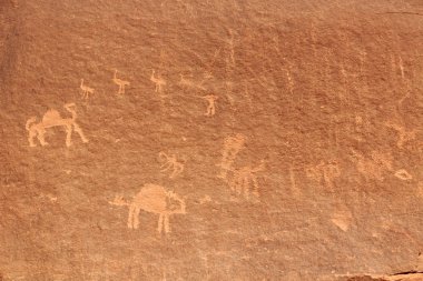 Thamudic and Nabataean petroglyphs and inscriptions on mountain in Wadi Rum desert, Jordan