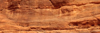 Thamudic and Nabataean petroglyphs and inscriptions on mountain in Wadi Rum desert, Jordan clipart