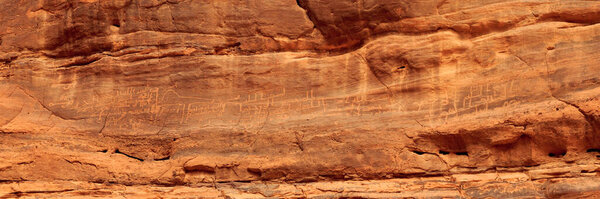 Thamudic and Nabataean petroglyphs and inscriptions on mountain in Wadi Rum desert, Jordan