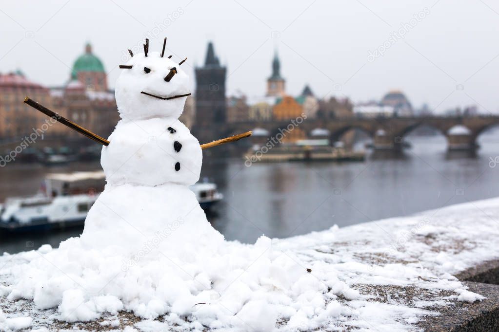 Snowman on the background of old Prague