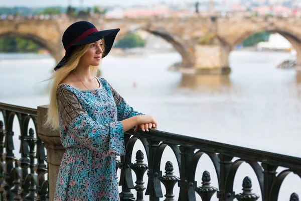 Portrait of the beautiful fashionable girl with hat on embankment in summer day — Stock Photo, Image