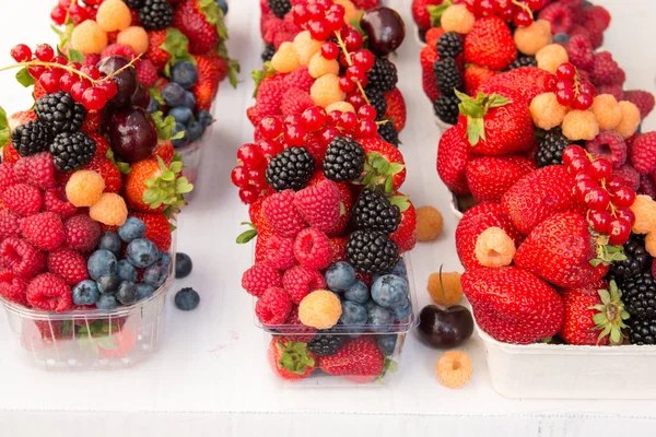 Ягодные фрукты на рынке. Черника, малина, клубника, вишня — стоковое фото