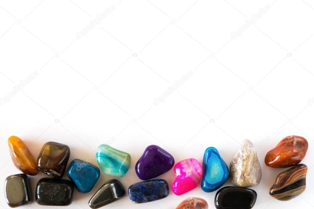 Collection of colorful semiprecious gemstones on white background