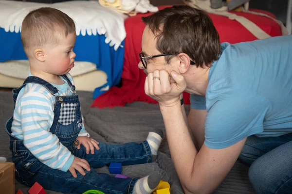 Cute baby boy with Down syndrome playing with dad — Stock Photo, Image