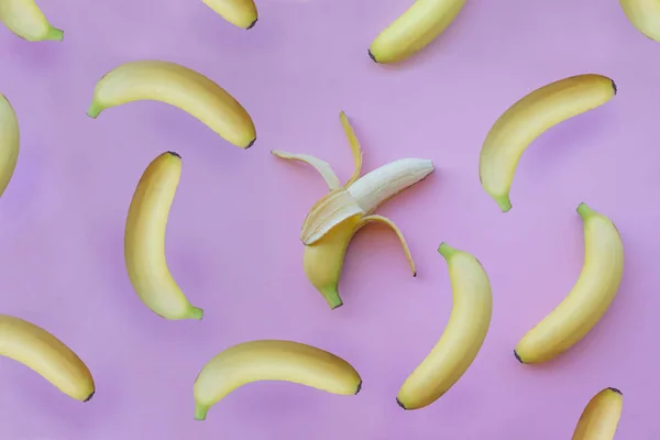 Färska gula bananer på rosa bakgrund — Stockfoto