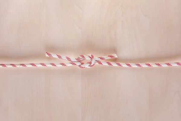 Square or reef ship knot on wooden background — 스톡 사진