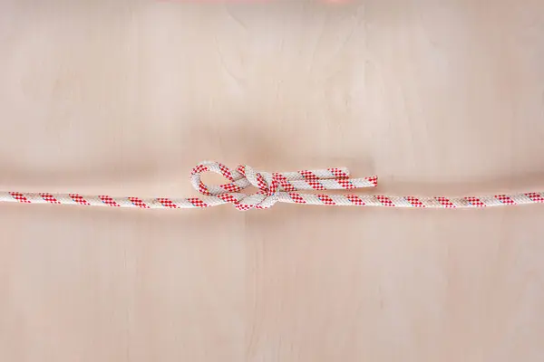Singly slipped reef ship knot on wooden background — 스톡 사진