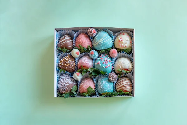 Geschenkdoos met handgemaakte aardbeien in chocolade op groene achtergrond met vrije ruimte voor tekst — Stockfoto