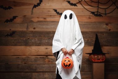 Cadılar Bayramı kavramı - halloween kabak şekeri kavanoz oyun ya da şeker ile eğri kabaklar yarasalar ve ahşap studio arka plan üzerinde örümcek ağı üzerinden yapmakla küçük beyaz hayalet.